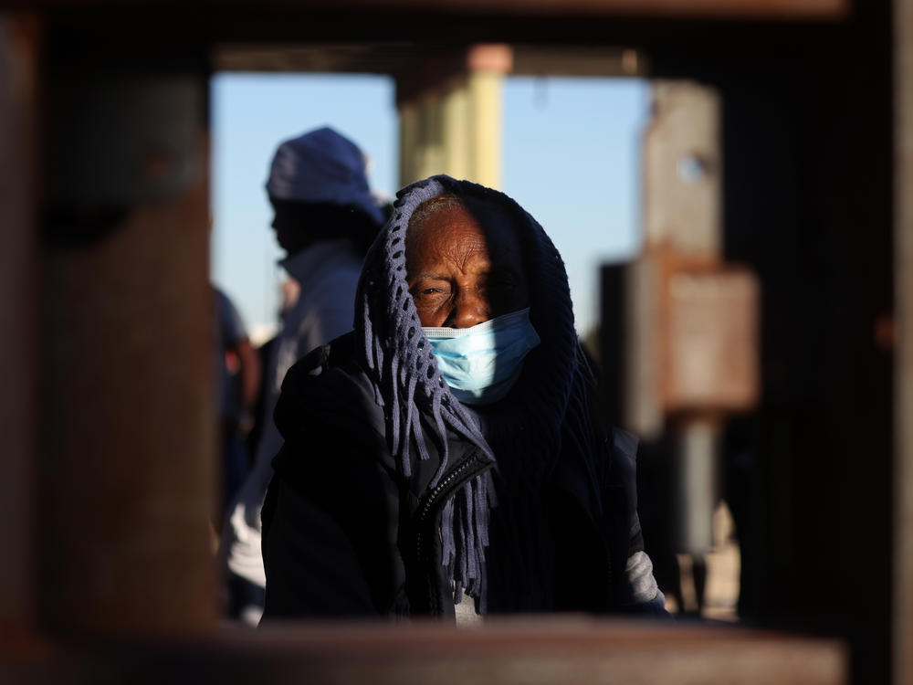 An asylum-seeking migrant from Nicaragua bundles up at the border as she waits to be processed by U.S. Customs and Border Protection after crossing the Rio Grande River into the United States in El Paso, Texas, U.S., December 22, 2022.