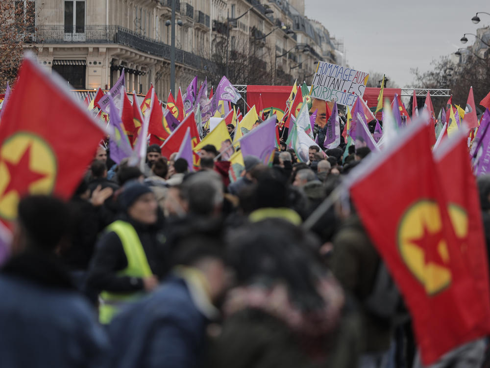 Kurdish activist and anti-racism group stage a protest against the recent shooting at the Kurdish culture center, holding Kurdistan Workers Party, PKK, flag in Paris, Saturday, Dec. 24, 2022. Kurdish activists, left-wing politicians and anti-racism groups are holding a protest Saturday in Paris after three people were killed at a Kurdish cultural center in an attack aimed at foreigners.