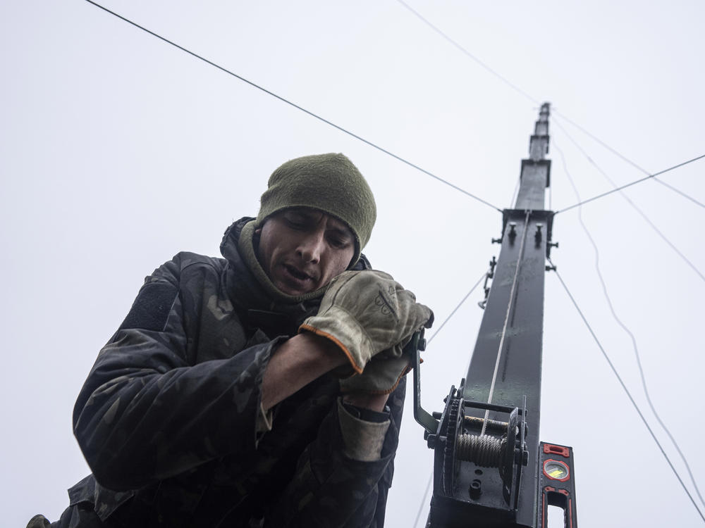 Ukrainian servicemen from 127 brigade prepare a telescopic tower with a remote camera installed on a Soviet car 