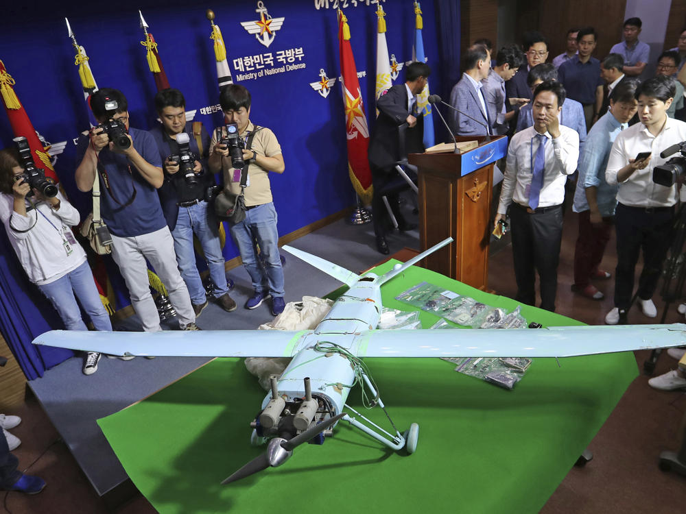 In this file photo from 2017, people view a suspected North Korean drone at South Korea's Defense Ministry in Seoul. The South Korean military fired warning shots and scrambled aircraft on Monday, saying that North Korean drones had entered their airspace.