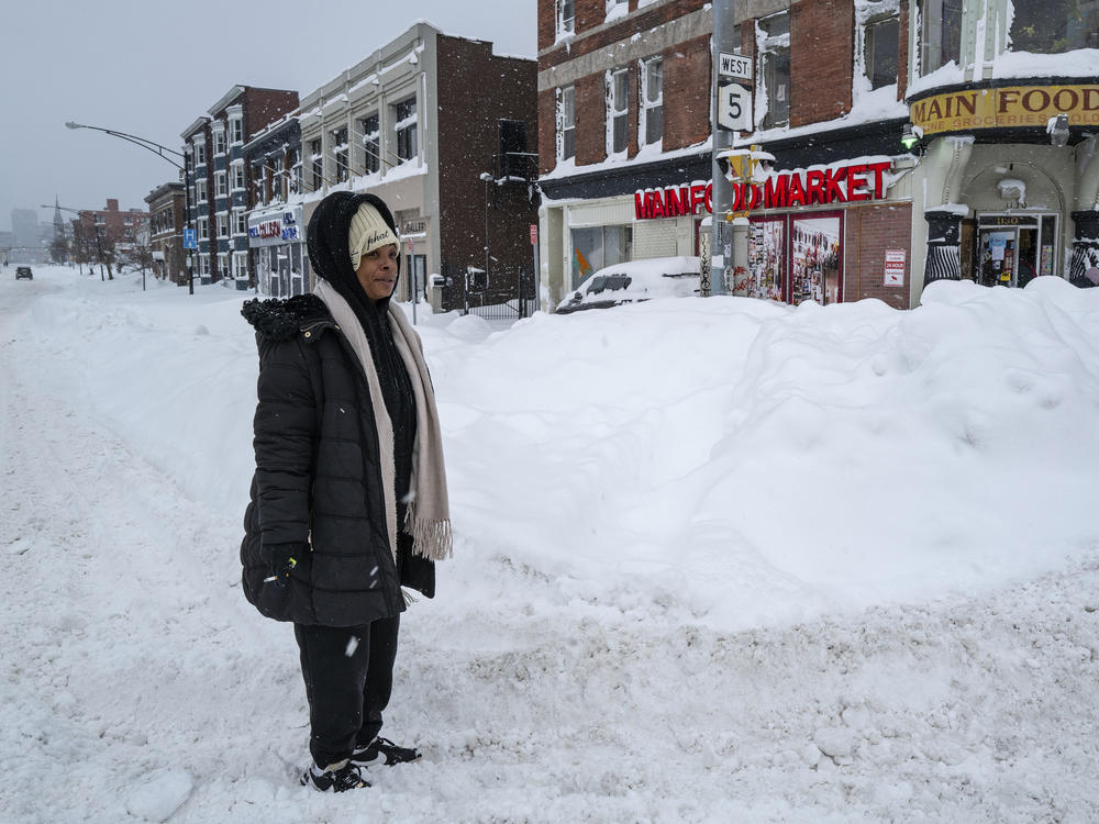 Kala Smith of Buffalo, N.Y., heads for a food store Monday on Main Street, not far from where she lives, after a massive snowstorm blanketed the city.