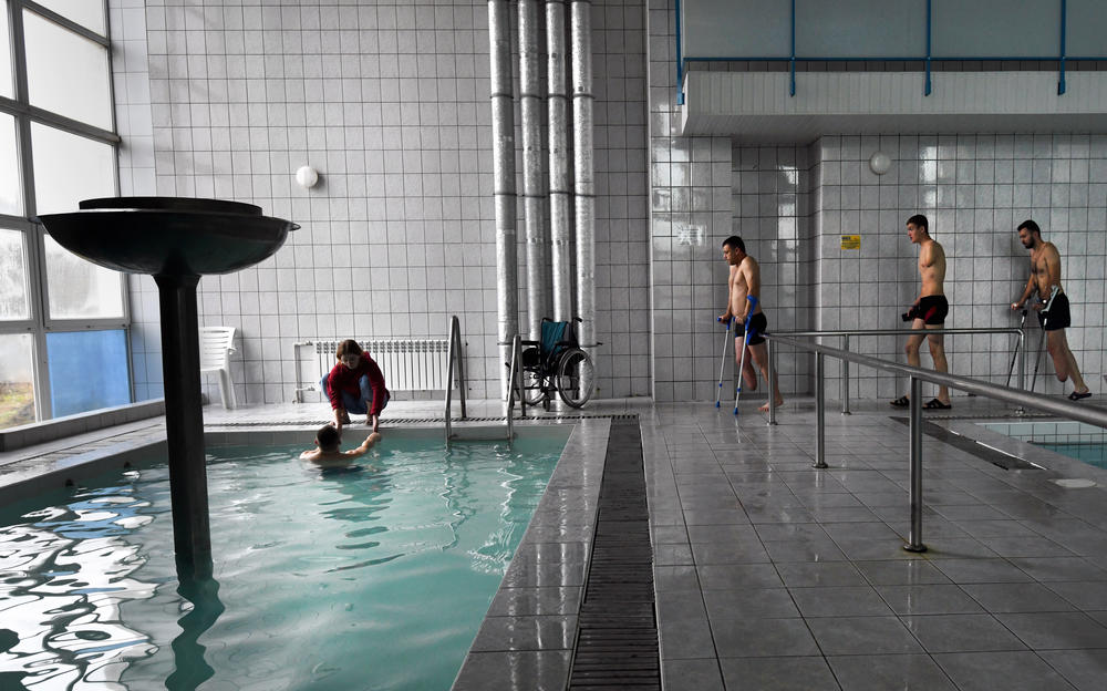 Misha and Ira take part in therapeutic swimming activity at a local pool in Truskavets, Ukraine.