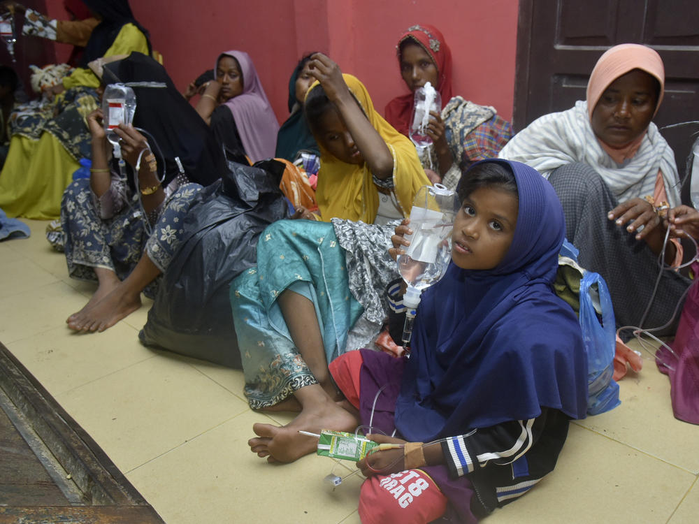 Ethnic Rohingya women and children sit on the floor upon arrival at a temporary shelter after their boat landed in Pidie, Aceh province, Indonesia, Monday, Dec. 26, 2022. A second group in two days of weak and exhausted Rohingya Muslims landed on a beach in Indonesia's northernmost province of Aceh on Monday after weeks at sea, officials said.