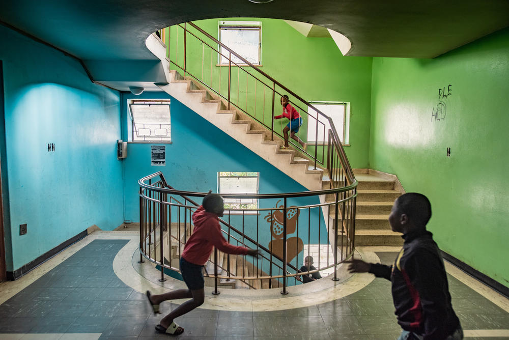 Boys play in a stairwell in Cissie Gool House, an abandoned hospital now home to over 1,000 people. By painting, decorating and maintaining the building, its new residents have managed to turn it into a decent home for themselves and their families within striking distance of central Cape Town.