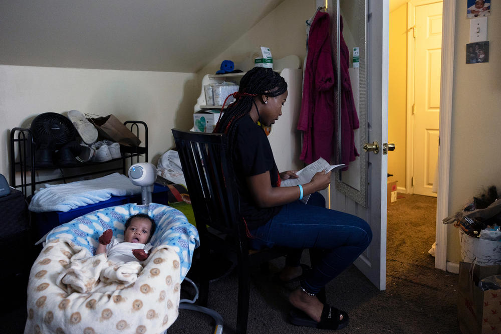 Ja'Mil'Lion DeLorenzo reads literature she's received from the Nurse-Family Partnership in her bedroom at her grandmother's home in Glenholden, Pa.