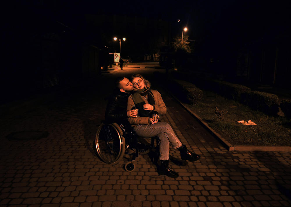 Misha and Ira rest on one of their walks near the hospital during a power outage. Taking walks together was one of their favorite things to do before the war.
