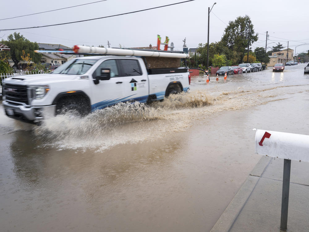 A truck is driven through a flooded intersection of Salinas, Calif., on Tuesday. The first in a week of storms brought gusty winds, rain and snow to California on Tuesday, starting in the north and spreading southward.