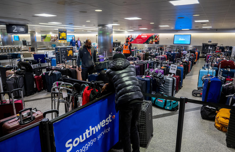 A traveler looks over unclaimed luggage at the William P. Hobby Airport on Wednesday in Houston.