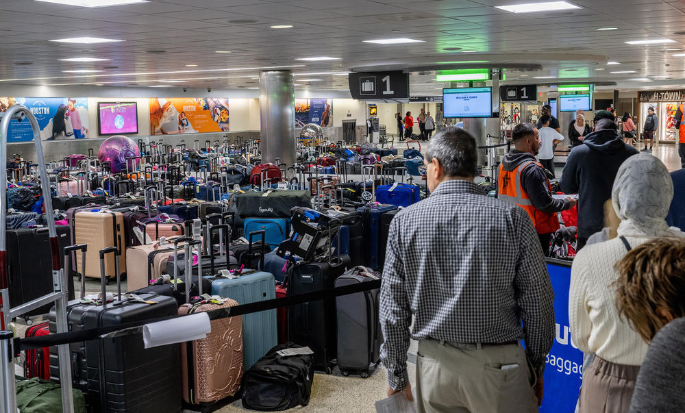 Travelers wait in line for help finding lost luggage at the William P. Hobby Airport on Wednesday in Houston.
