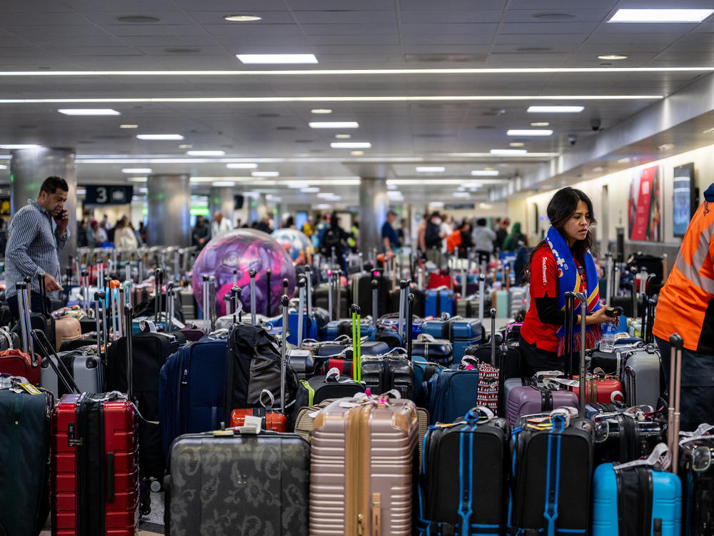 Airline staff search through unclaimed luggage at the William P. Hobby Airport on Wednesday in Houston.