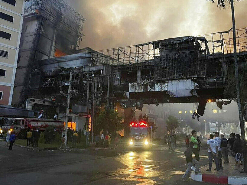 In this photo provided by Cambodia's Fresh News, smoke rises as a fire burns Thursday through the Grand Diamond City Casino and Hotel near a Cambodia-Thai international border gate in Poipet, Cambodia.