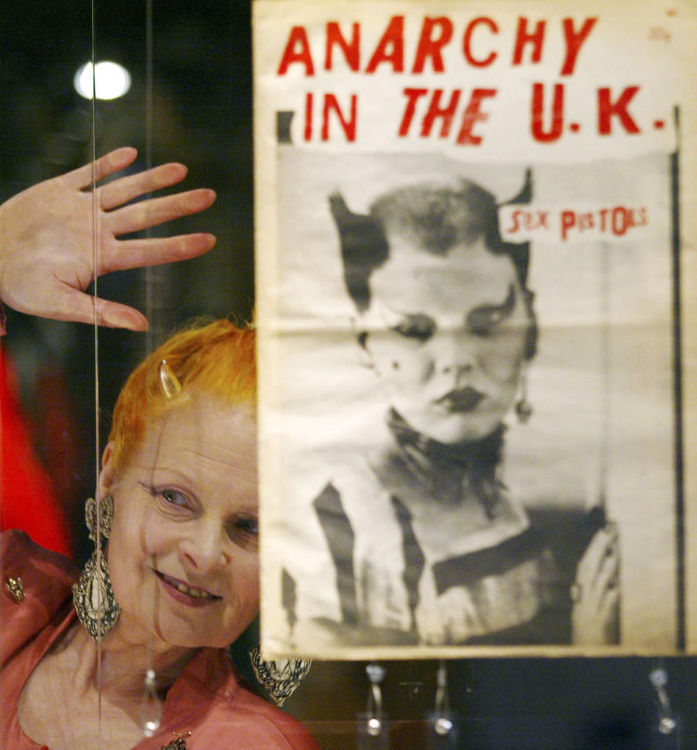 Designer Vivienne Westwood looks through the glass toward the media during a photocall at a retrospective exhibition to celebrate her 30 years in the fashion industry, at the Victoria and Albert Museum in London, Tuesday March 30, 2004.