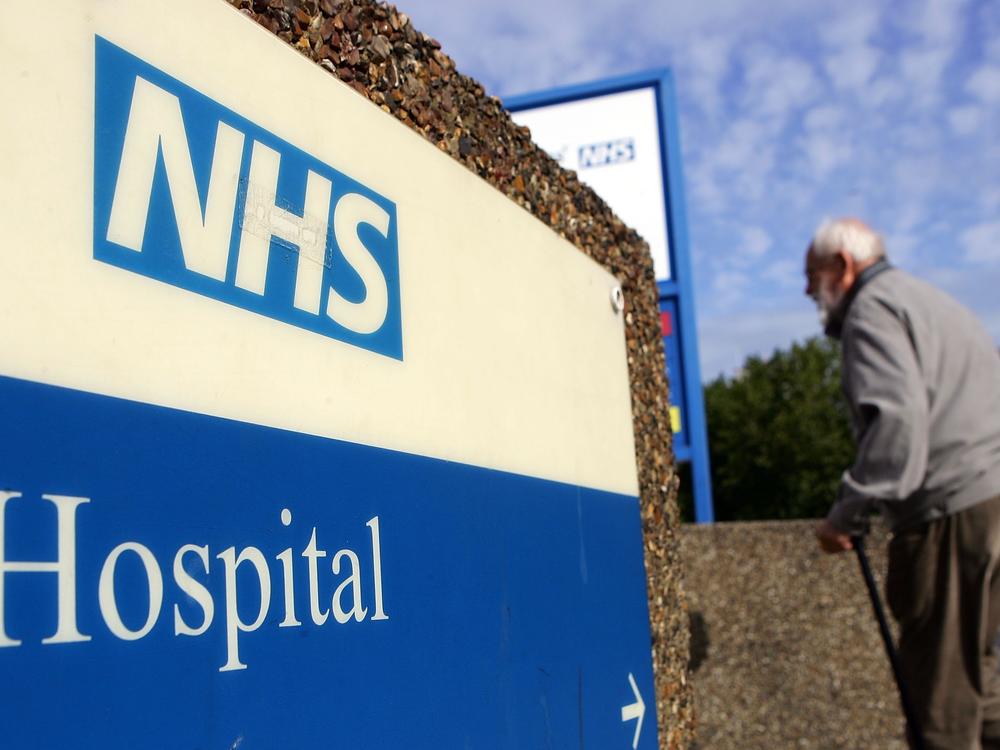A man walks past a National Health Service sign in 2007 in London. The NHS offers services at the Askern Medical Practice in Doncaster, whose patients mistakenly received text messages informing them of a terminal cancer diagnosis.