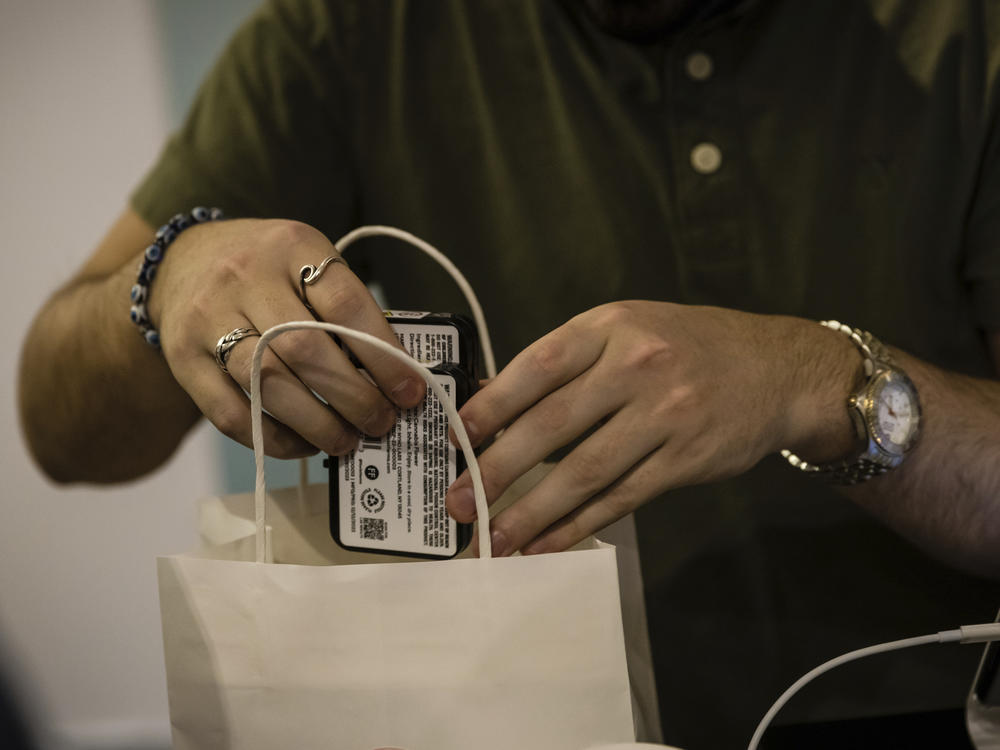 A cashier puts cannabis products into a bag at the Housing Works Cannabis Co., New York's first legal cannabis dispensary at 750 Broadway in Noho on Thursday, Dec. 29, 2022, in New York.