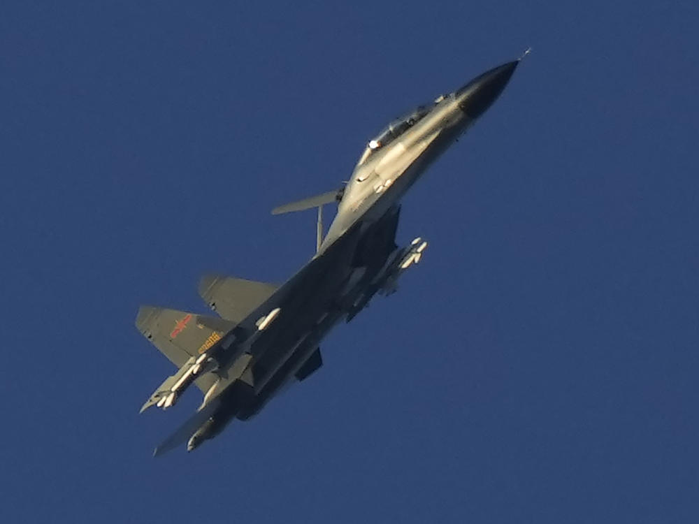 A Chinese J-11 military fighter jet flies above the Taiwan Strait near Pingtan, the closest land of mainland China to the island of Taiwan, in southeastern China's Fujian Province on Aug. 5, 2022.