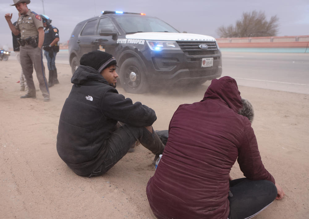 Undocumented migrants from Venezuela are detained on Wednesday by the Texas National Guard and law enforcement after crossing the Rio Grande.