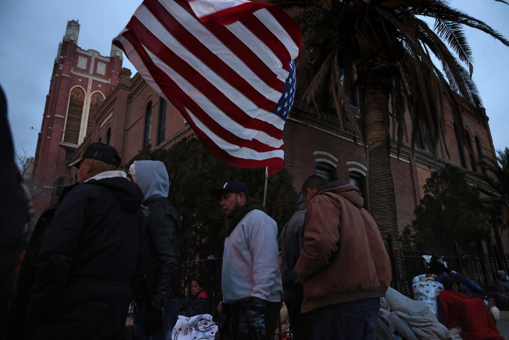 Unsheltered migrants gather for food on Wednesday near El Paso's Sacred Heart Church after crossing the Rio Grande.