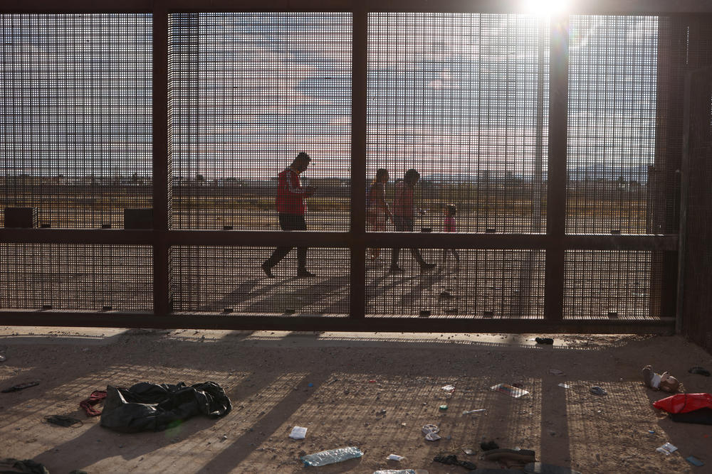 Asylum-seeking migrants walk to where they can go through the border wall and be processed by U.S. Customs and Border Protection after crossing the Rio Grande into the United States in El Paso, Texas, on Thursday.