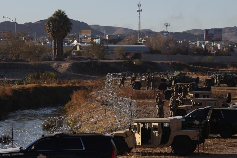 The Texas National Guard monitors a small stretch of the Rio Grande and have lined it with razor wire as they attempt to stop asylum-seeking migrants from crossing into the United States in El Paso on Dec. 21.