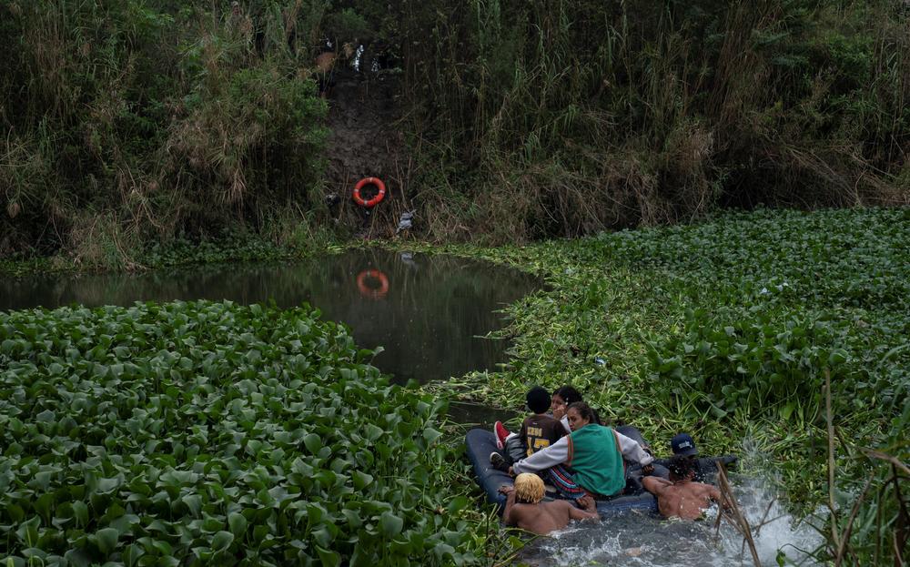 Asylum seekers cross the Rio Grande River into Brownsville, Texas, on Dec. 22.