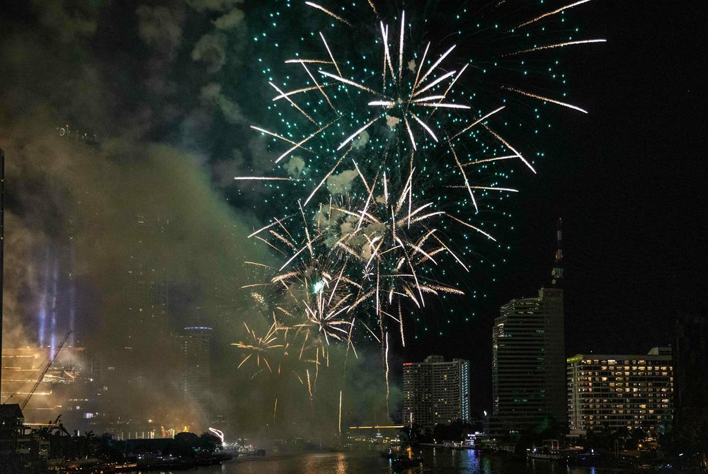 Fireworks explode over the King Taksin Bridge in Bangkok, Thailand.