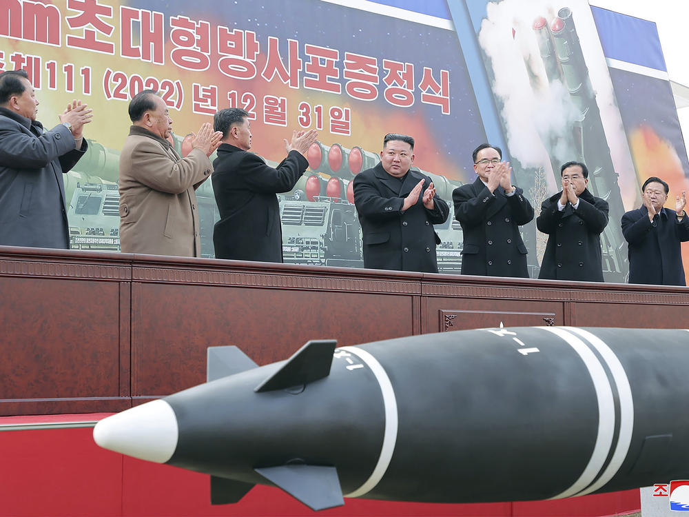 In this photo provided by the North Korean government, North Korean leader Kim Jong Un, center, attends a ceremony of donating 600 mm super-large multiple launch rocket system at a garden of the Workers' Party of Korea headquarters in Pyongyang, North Korea, on Saturday, Dec. 31, 2022.