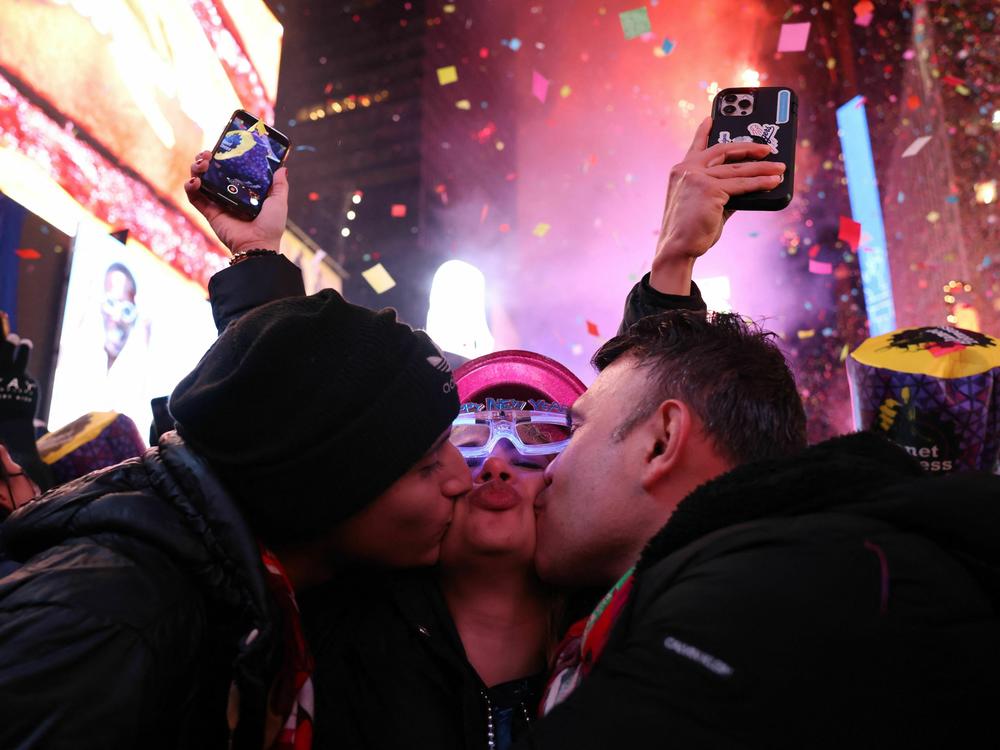 People kiss as confetti fills the air to mark the beginning of the new year, in Times Square, New York City, on Jan. 1, 2023.