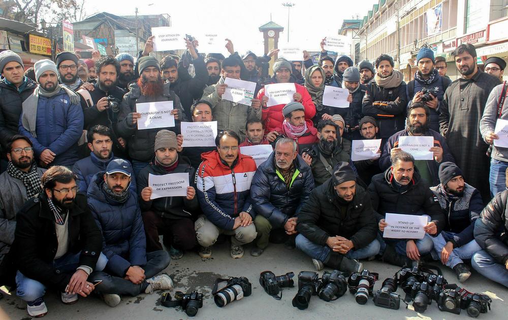 Kashmiri journalists hold placards during a protest march in Srinagar on January 26, 2019. Dozens of journalists marched in protest after authorities barred at least half a dozen journalists from entering the venue of India's Republic Day parade in Srinagar, local media said.