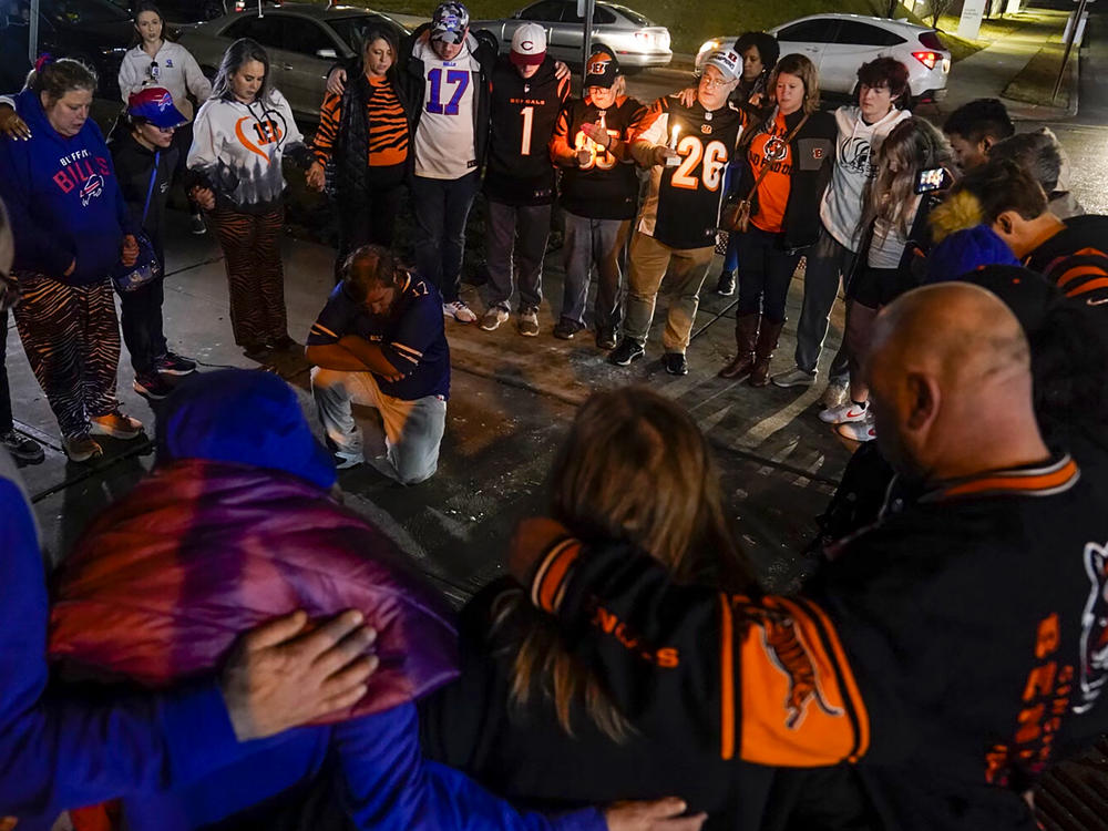 Fans gather outside University of Cincinnati Medical Center, late Monday in Cincinnati, where the Buffalo Bills' Damar Hamlin was taken after collapsing on the field during an NFL football game against the Cincinnati Bengals.