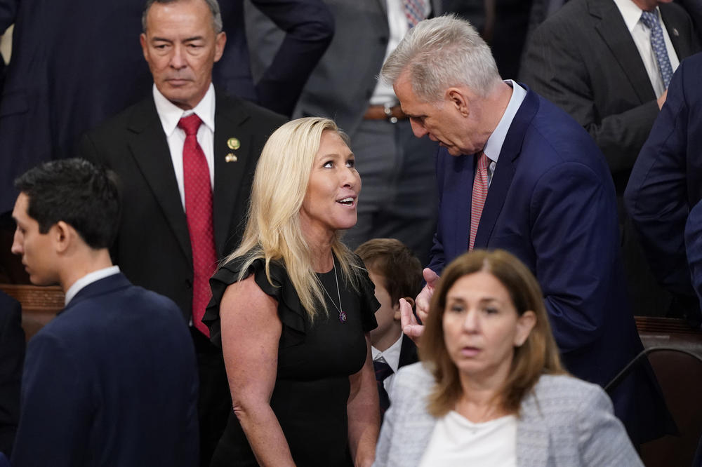 Rep. Marjorie Taylor Greene, R-Ga., talks with Rep. Kevin McCarthy, R-Calif., during the vote for House Speaker on the opening day of the 118th Congress at the U.S. Capitol, Tuesday, Jan. 3, 2023, in Washington.