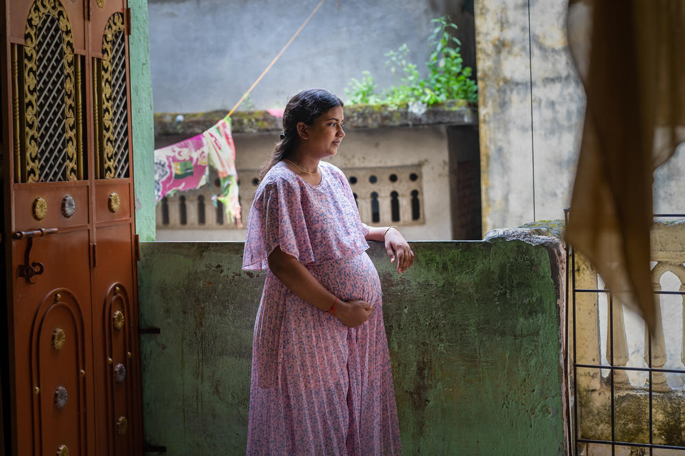 Naina Agrahari, 24, a migrant from Uttar Pradesh, stands in the corridor of her building in Nalla Sopara on the outskirts of Mumbai. She is the first woman in her immediate family to have a paid career — as a financial consultant — outside the home. And she's the first to give birth in a hospital. The photo was taken on Oct. 12. Her son was born on Nov. 9.