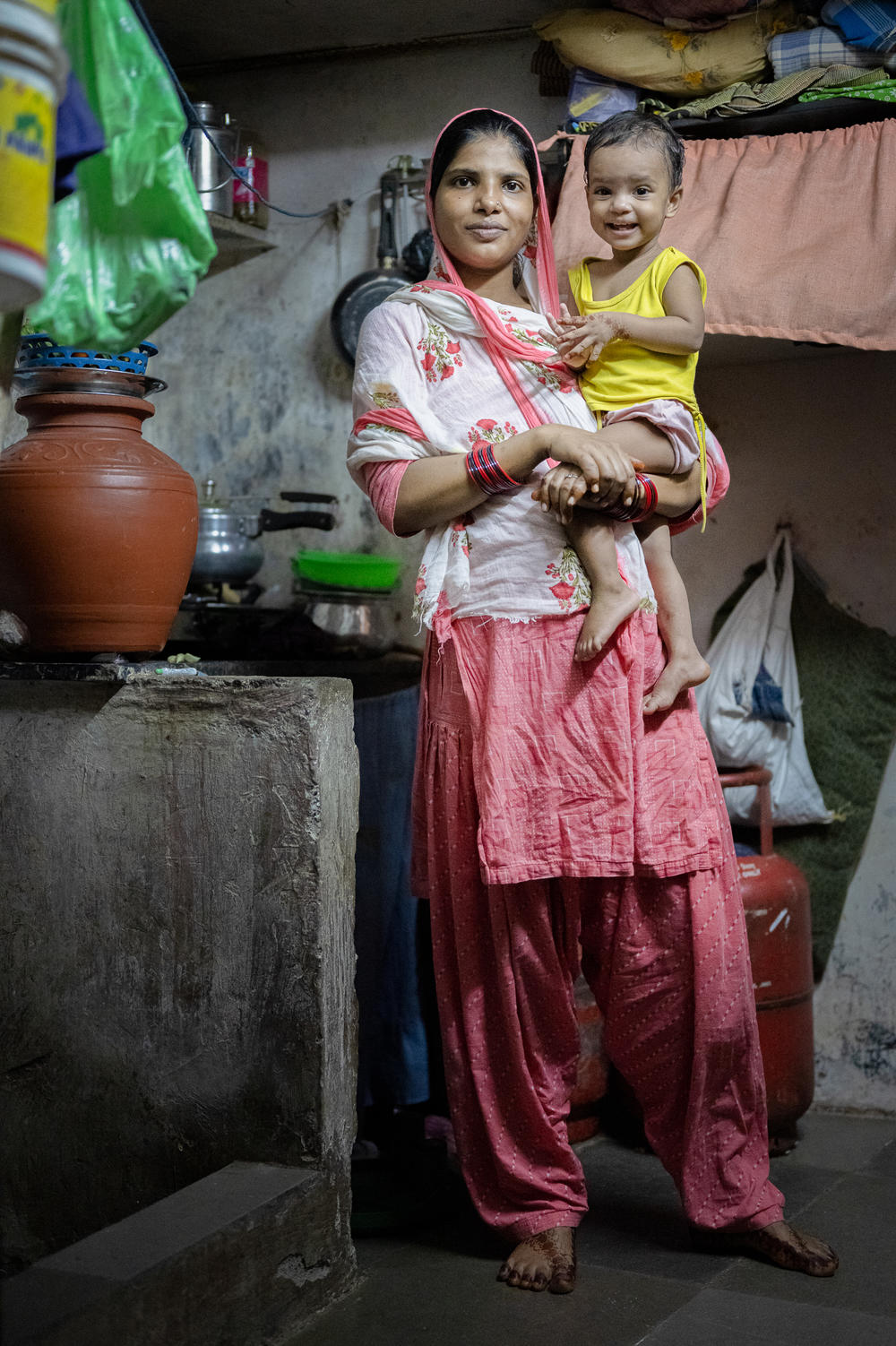 Shabana Khatoon, 23, holds her 9-month-old daughter, Adeeba, at their home in Dharavi. Khatoon's daughter was diagnosed as malnourished when the family arrived in Mumbai from the relatively poor Indian state of Jharkhand. Now Khatoon is pregnant again — and gets visits from a social worker with advice on prenatal care.