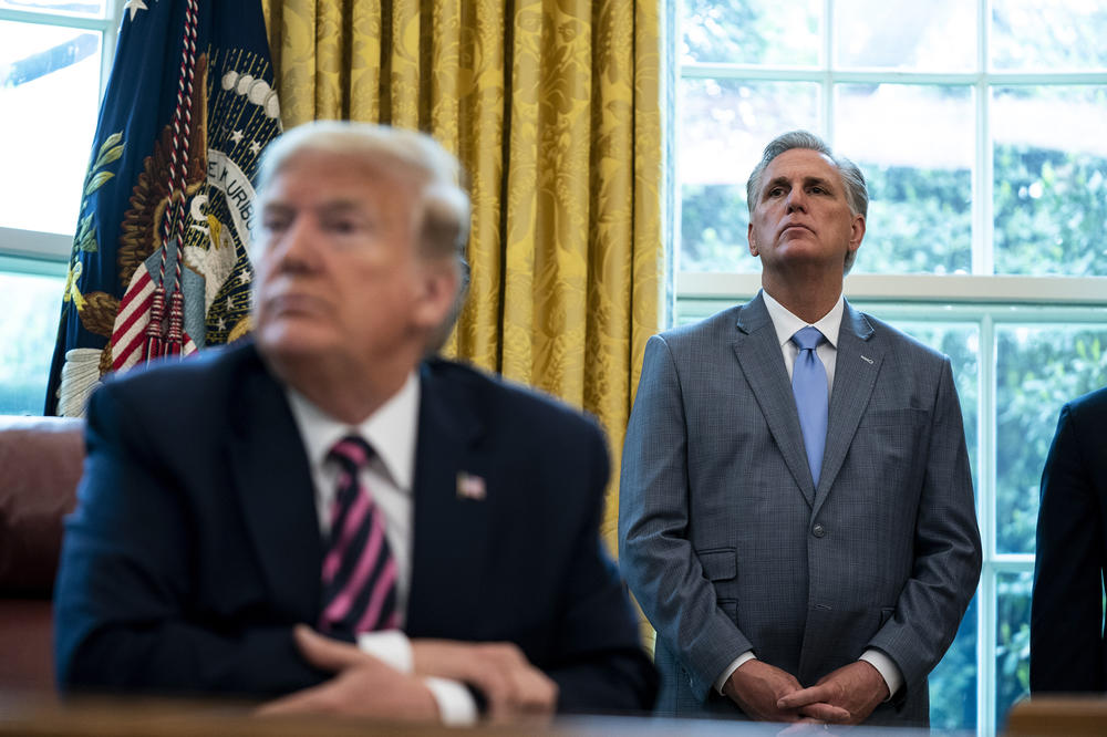 Then-House Minority Leader Rep. Kevin McCarthy, R-Calif., and then-President Donald Trump attend a signing ceremony for H.R. 266, the Paycheck Protection Program and Health Care Enhancement Act, in the Oval Office of the White House on April 24, 2020.