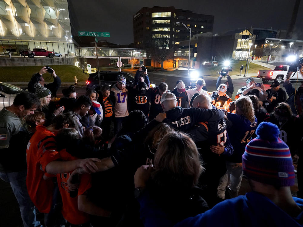 Football fans gather for a vigil at the University of Cincinnati Medical Center for football player Damar Hamlin of the Buffalo Bills, who collapsed after making a tackle during Monday night's game against the Cincinnati Bengals.