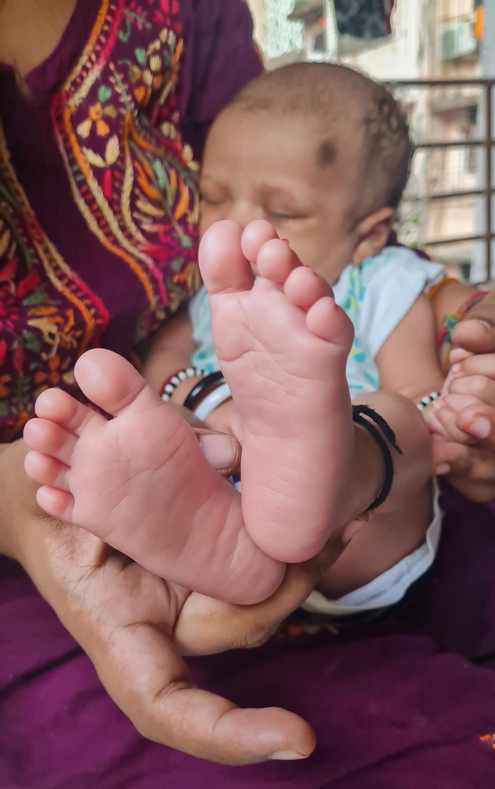 Naina Agrahari, 24, with her newborn son Vehant Singh, at her mother's home in northern Mumbai.