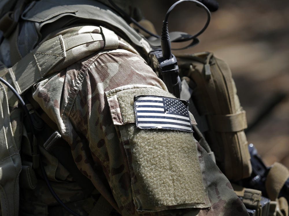 In this photo taken Friday, April 21, 2017 a United States flag patch adorns the uniform of a paratrooper with the 82nd Airborne Division's 3rd Brigade Combat Team during a training exercise at Fort Bragg, N.C.