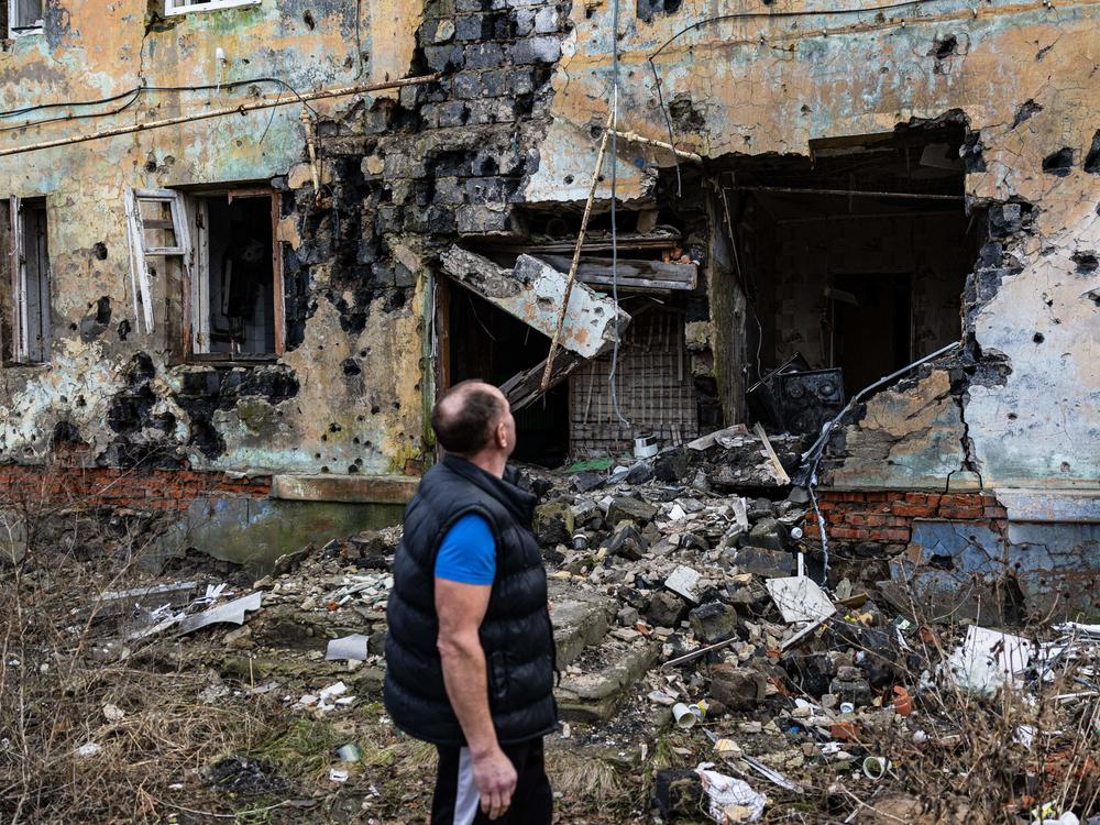 Andryi Pleshan checks destruction around his shelter in the city of Izium in eastern Ukraine on Jan. 2.