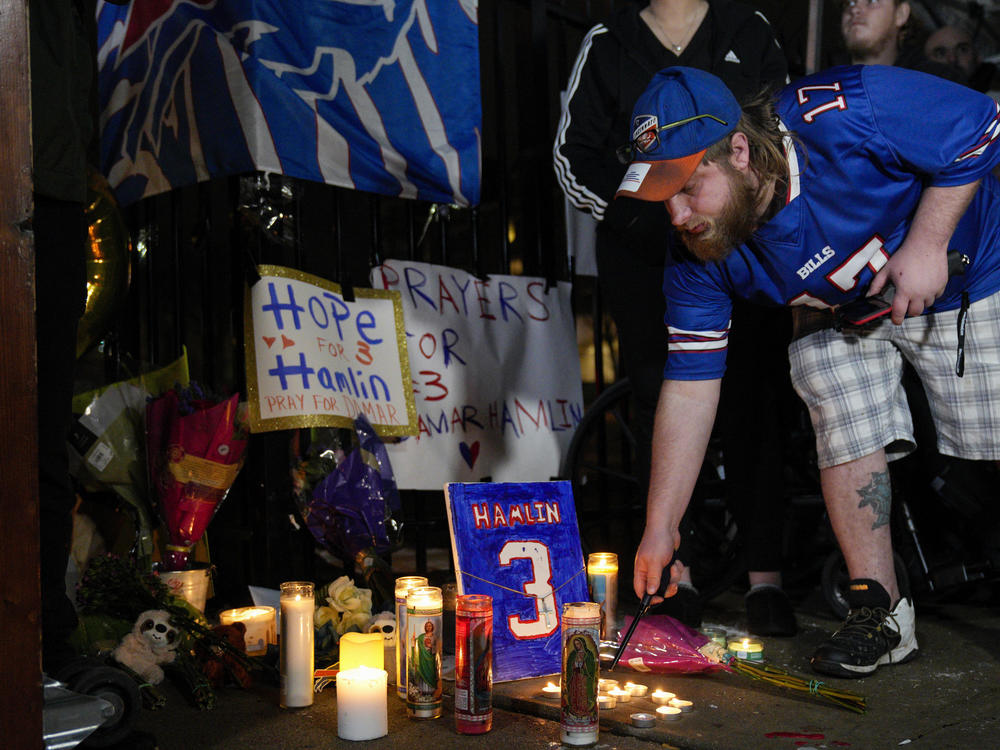Buffalo Bills fan Dustin Peters attends a candlelight vigil for Bills safety Damar Hamlin at the University of Cincinnati Medical Center on Tuesday.