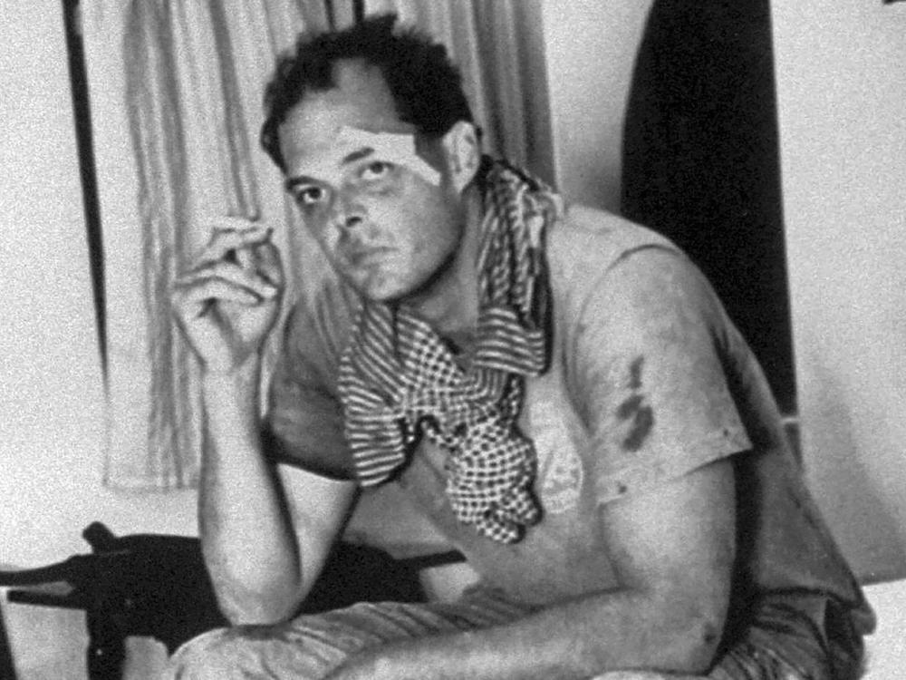American journalist Nate Thayer sits bandaged in a hotel room on Oct. 15, 1989, in Aranyaprathet, Thailand, after he was injured in a land mine explosion. Thayer survived several brushes with death over decades covering conflict in Southeast Asia and was the last Western journalist to interview Pol Pot. He was found dead at his home in Falmouth, Mass., on Tuesday.