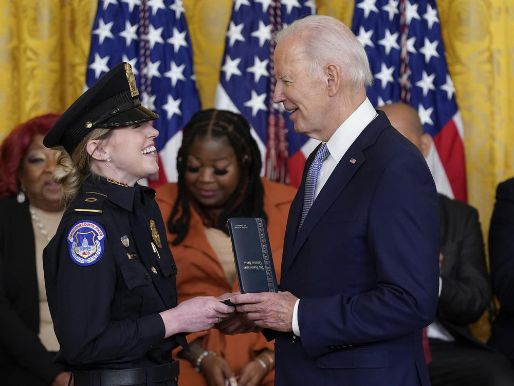 President Biden awards the Presidential Citizens Medal, the nation's second-highest civilian honor, to U.S. Capitol Police officer Caroline Edwards during a ceremony to mark the second anniversary of the Jan. 6 assault on the Capitol in the East Room of the White House on Friday.