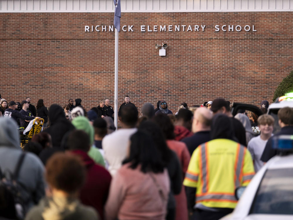 Students and police gather outside of Richneck Elementary School after a shooting on Friday, Jan. 6, in Newport News, Va. A shooting at a Virginia elementary school sent a teacher to the hospital and ended with 