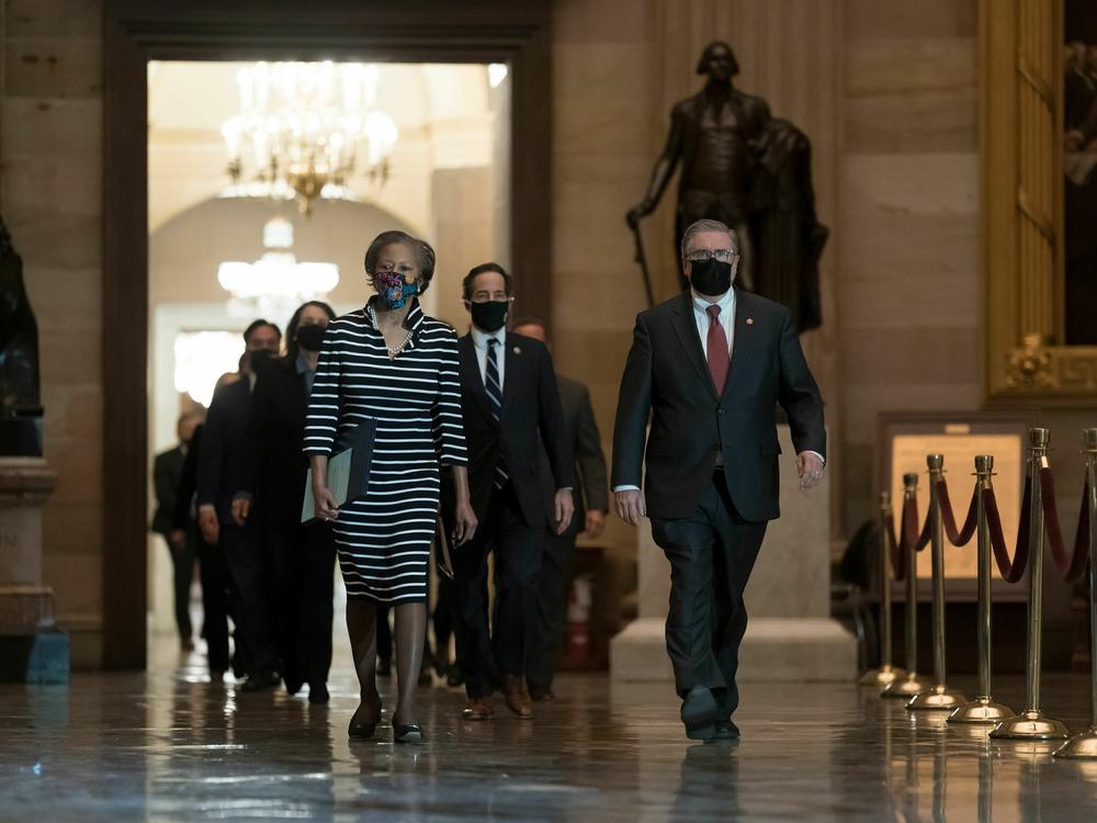 Cheryl Johnson (L), clerk of the House of Representatives, carries an article of impeachment against former President Donald Trump to the Senate on Jan. 25, 2021.