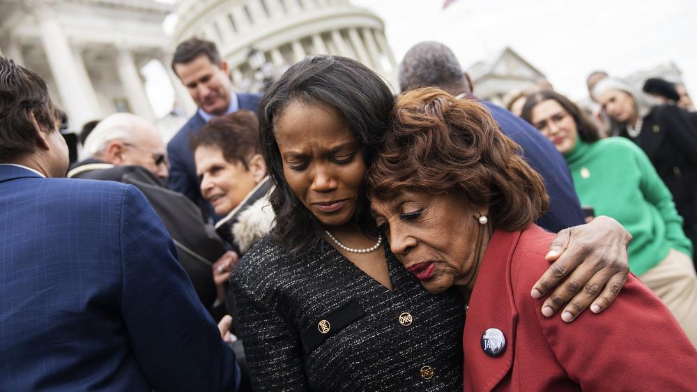 Dr. Serena Liebengood, center, the wife of the late U.S. Capitol Police Officer Howard Liebengood, and Rep. Maxine Waters, D-Calif., embrace during a ceremony to mark second anniversary of January 6th riot at the U.S. Capitol on Friday. Officer Liebengood will receive the Presidential Citizens Medal posthumously later Friday.