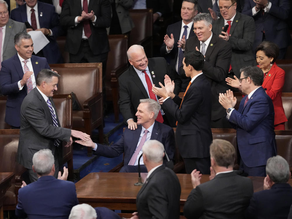 Rep. Kevin McCarthy, R-Calif., is congratulated after winning the 15th vote in the House chamber as the House enters the fifth day trying to elect a speaker and convene the 118th Congress in Washington, early Saturday.