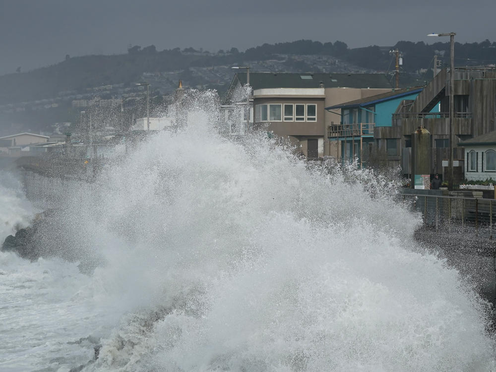 Waves crash into a seawall in Pacifica, Calif., Friday, Jan. 6, 2023. California weather calmed Friday but the lull was expected to be brief as more Pacific storms lined up to blast into the state, where successive powerful weather systems have knocked out power to thousands, battered the coastline, flooded streets, toppled trees and caused at least six deaths.