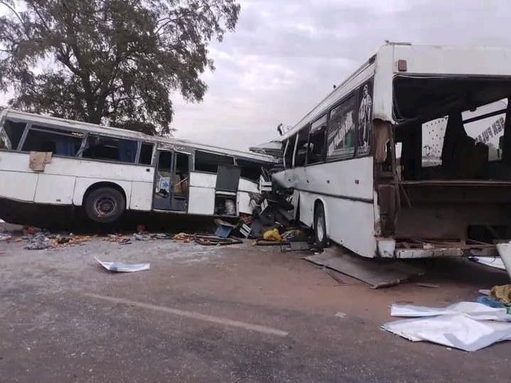 Two damaged buses are pictured after they collided on a road in Gniby, Senegal, on Sunday. At least 40 people were killed and dozens injured in crash.