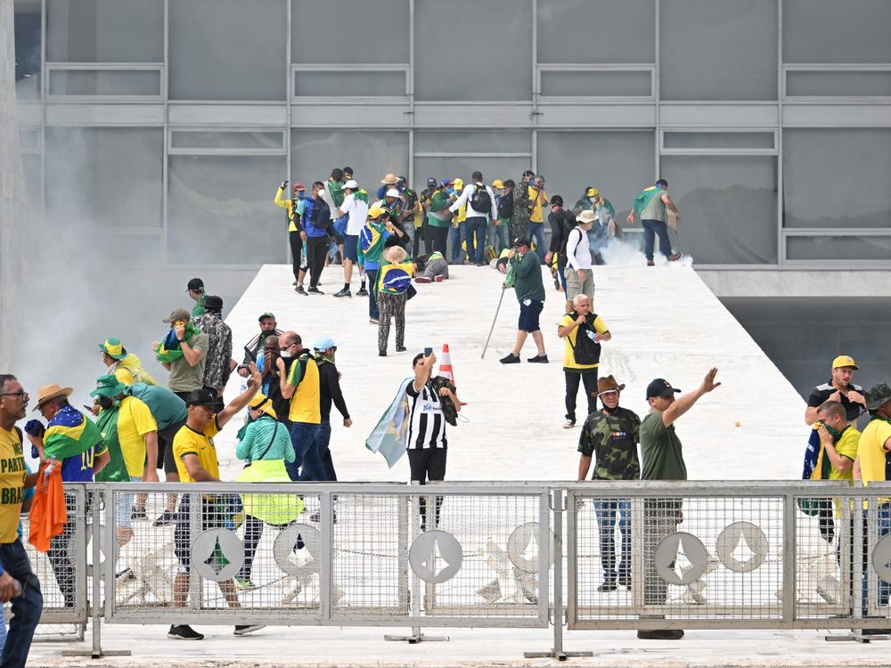 Supporters of Brazilian former President Jair Bolsonaro clash with the police during a demonstration outside Brazil's National Congress headquarters in Brasilia on Sunday.