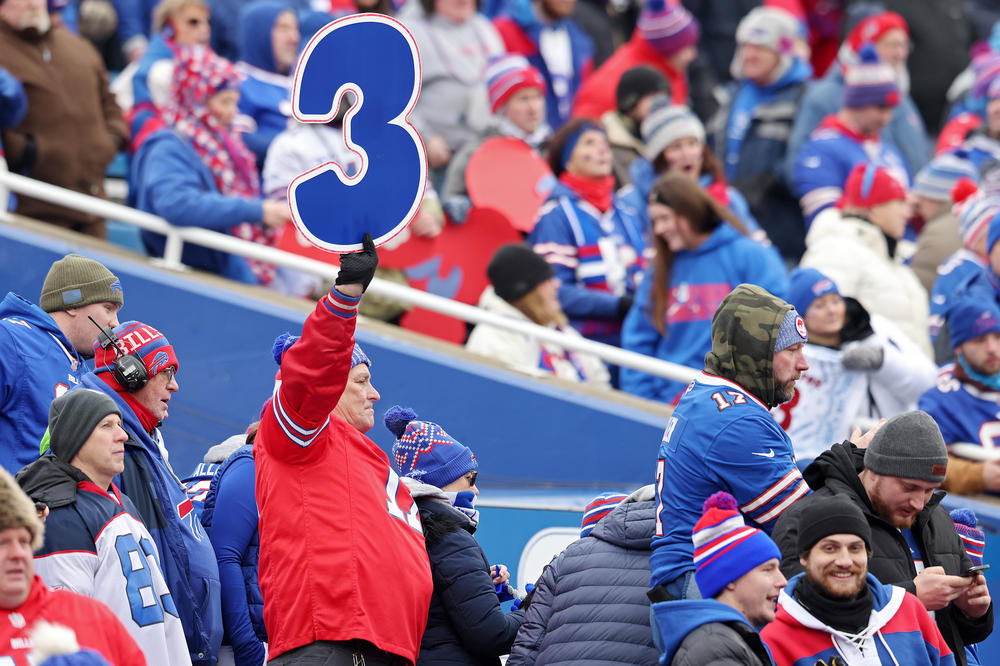A Buffalo Bills fan holds a sign in support of Buffalo Bills safety Damar Hamlin during a game against the New England Patriots Sunday. Hamlin remains hospitalized after suffering a cardiac arrest and collapsing during a game Monday night.