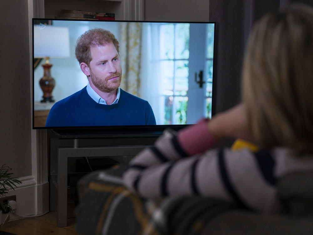 A person at home in Edinburgh, United Kingdom, watches Prince Harry, the Duke of Sussex, being interviewed by ITV's Tom Bradby during 