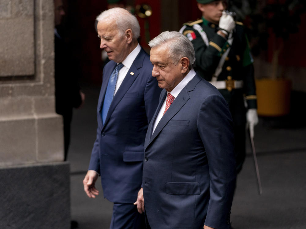 President Biden walks with Mexican President Andrés Manuel López Obrador at the National Palace in Mexico City on Jan. 9.